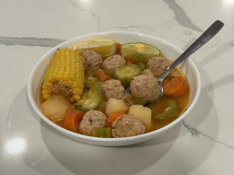 Homemade turkey albóndigas soup with potatoes, zucchini, carrots, celery, and corn in a rich tomato broth.