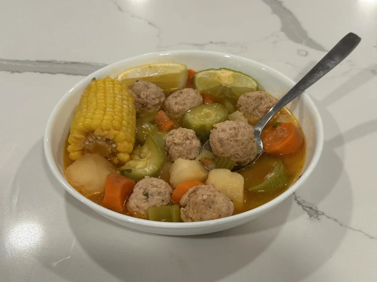 Homemade turkey albóndigas soup with potatoes, zucchini, carrots, celery, and corn in a rich tomato broth.