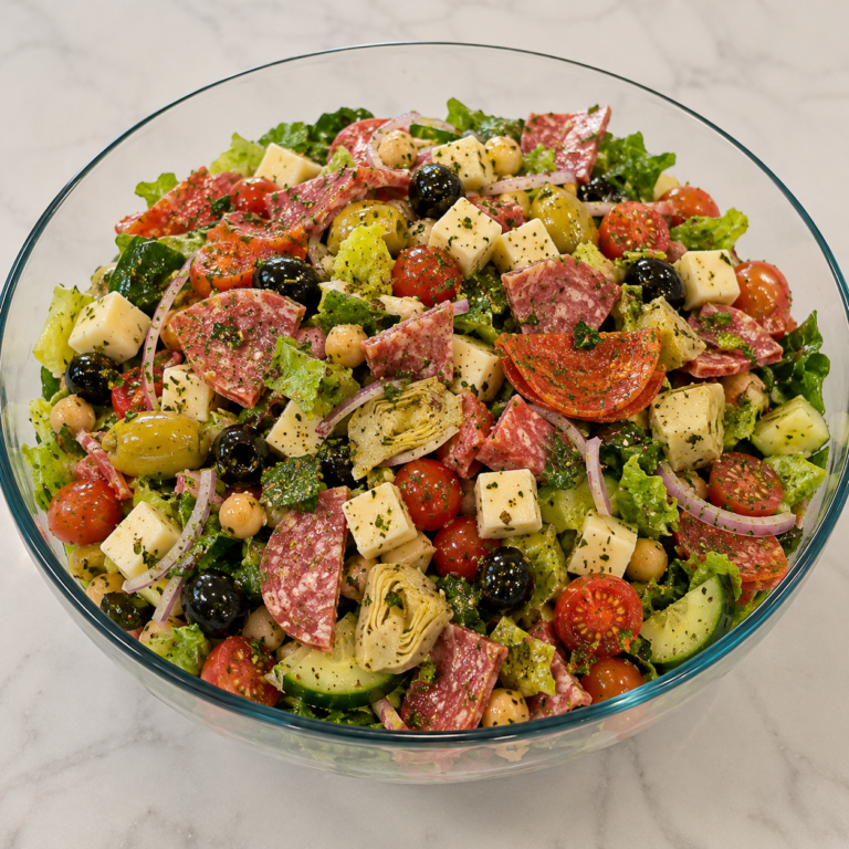 Homemade Antipasto Salad with salami, cheese, olives, cucumbers, tomatoes, chickpeas, pepperoncini, and romaine lettuce from Reynaldo’s Cocina