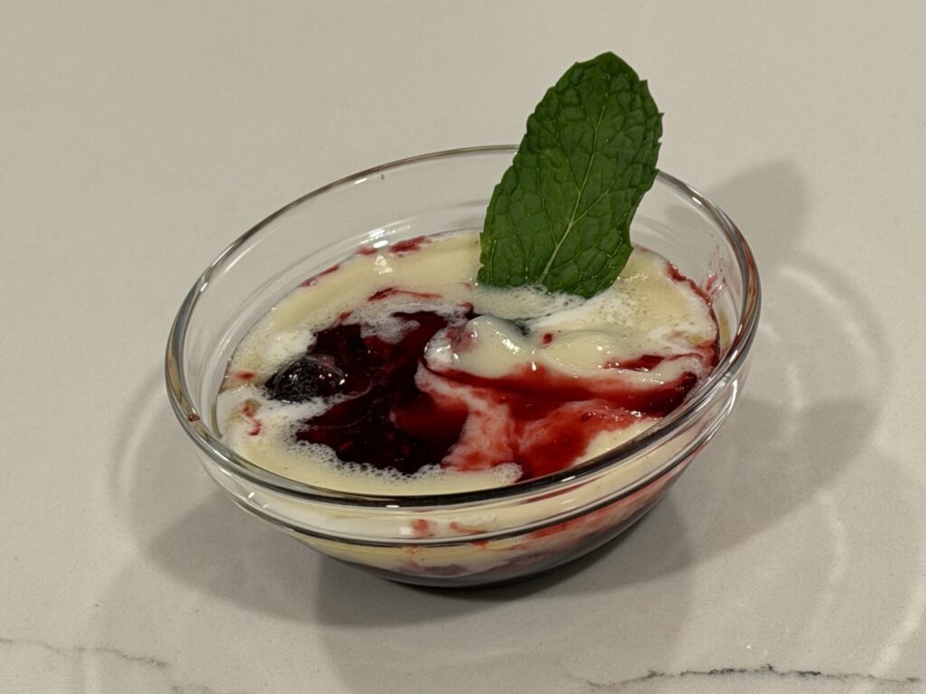 Berry mascarpone tart dessert with fresh mint garnish in glass serving dish by Reynaldo’s Cocina