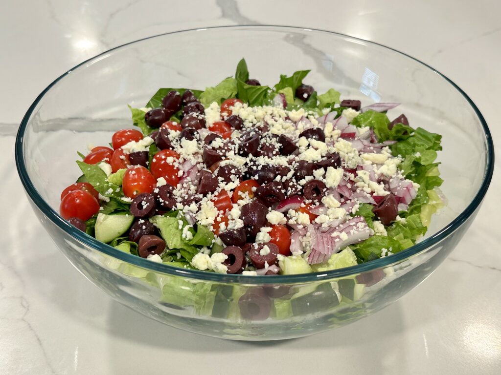Greek Salad Greek Salad with romaine lettuce, cucumbers, cherry tomatoes, red onion, kalamata olives, feta cheese, and homemade vinaigrette.