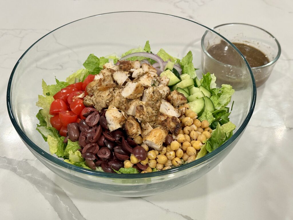 Herb Chicken Salad Herb Chicken Salad with grilled chicken, chickpeas, kalamata olives, cucumbers, tomatoes, red onion, and homemade vinaigrette.
