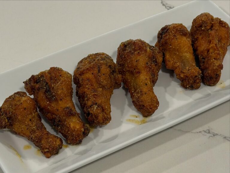 Homemade crispy Honey Lemon Pepper Wings coated in a savory honey butter sauce with fresh lemon juice, lemon zest, and cracked pepper.