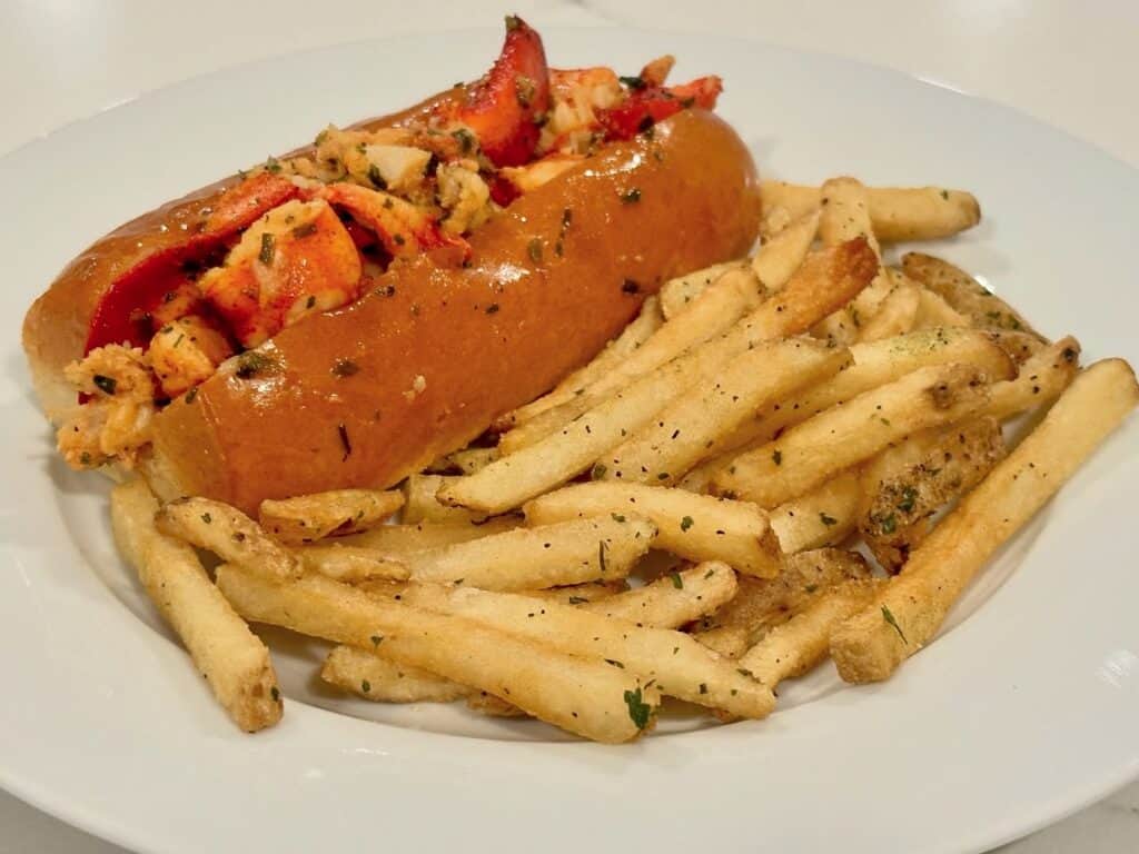 Homemade lobster roll served on a buttery toasted bun with seasoned truffle fries.