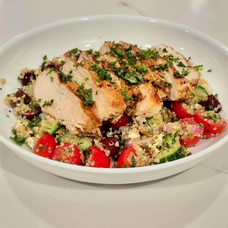 Mediterranean grilled chicken served over quinoa salad with cucumber, tomatoes, olives, red onion, and fresh herbs.
