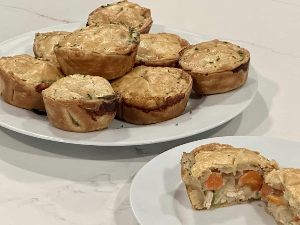 Homemade mini chicken pot pies filled with creamy chicken, carrots, and vegetables baked in flaky golden crust.