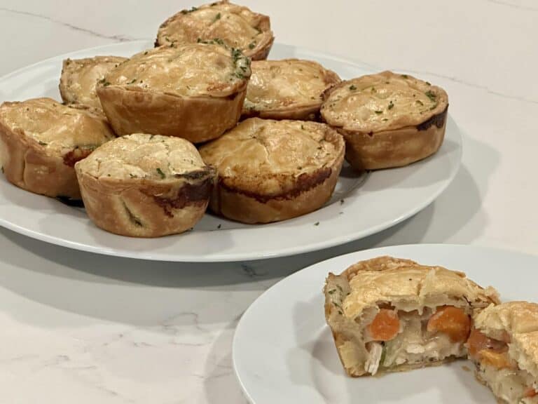 Homemade mini chicken pot pies filled with creamy chicken, carrots, and vegetables baked in flaky golden crust.