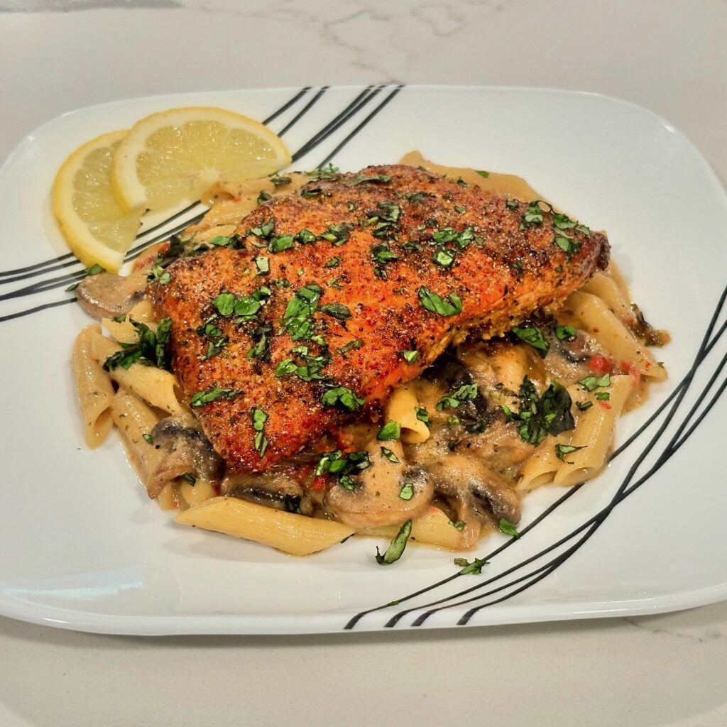 Monterey style Atlantic salmon served over creamy penne Alfredo with sautéed mushrooms, sun-dried tomatoes, lemon, and fresh basil.