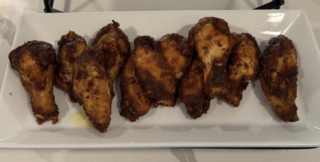 Crispy fried chicken wings tossed in butter and Badia Mango Pepper seasoning.