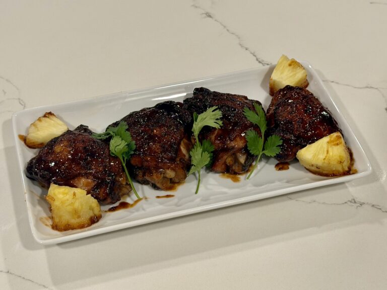 These Chipotle Pineapple Chicken Thighs combine tender bone-in chicken, savory seasoning, light chipotle heat, and a sweet pineapple barbecue glaze. The thighs are pan-seared for color, brushed with sauce, and finished in the oven until tender and caramelized.